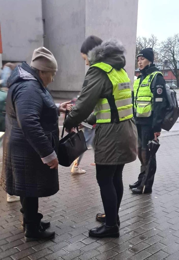 Praeivei gatvėje dovanojamas atšvaitas